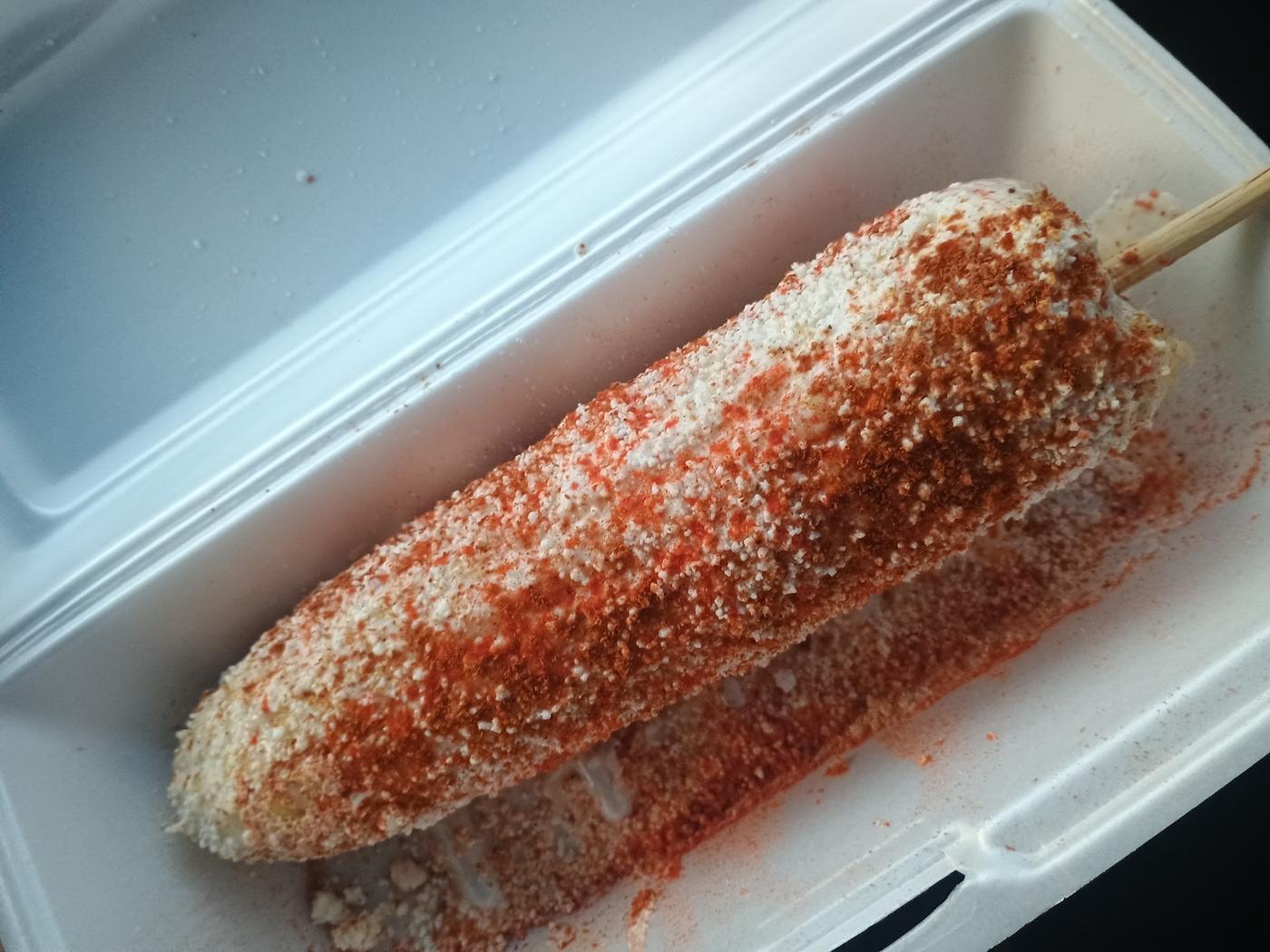 Corn on the cob dressed with mayo, cotija cheese and chili powder